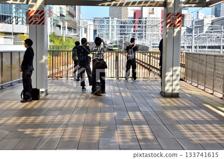 Young people taking photos of trains on the platform at Takanawa Gateway Station Young people taking photos of trains on the platform at Takanawa Gateway Station 133741615