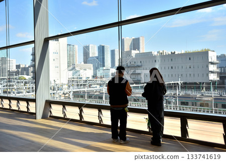 A couple in the observation deck at JR Takanawa Gateway Station A couple in the observation deck at JR Takanawa Gateway Station 133741619