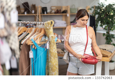 Woman view assortment in clothing department, buying lady handbag Woman view assortment in clothing department, buying lady handbag 133742063