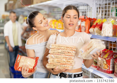 Two women choosing noodles in store 133742380