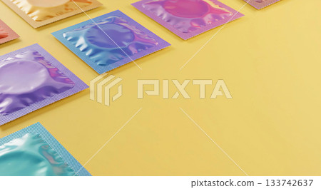 Colorful fun condom wrappers on yellow pastel background, copy space. Safe sex protection contraceptive wallpaper backdrop, fun vibrant condoms, STD prevention 133742637