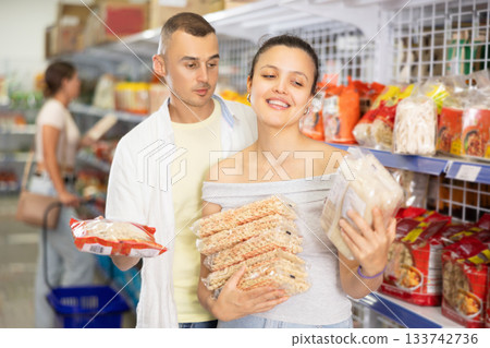 Man and woman couple choosing noodles Man and woman couple choosing noodles 133742736