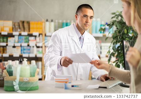 male pharmacist consults a client male pharmacist consults a client 133742737