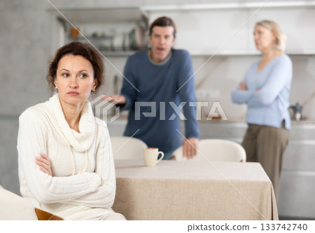 Man and mature mom yell to woman Man and mature mom yell to woman 133742740