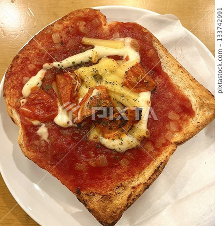 Golden, crispy toast topped with butter and jam, perfect for breakfast or snack-related projects. This image captures the warmth and comfort of a simple yet satisfying meal. 133742991