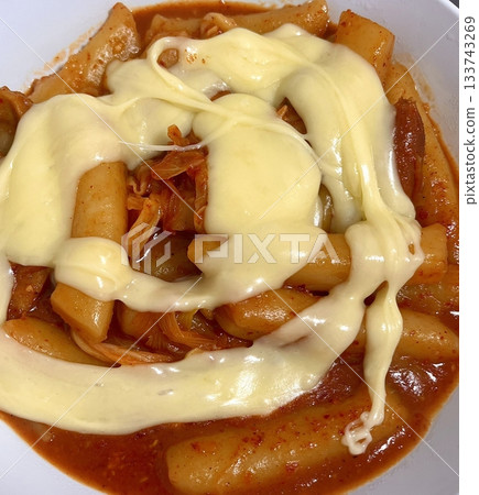Spicy Korean tteokbokki with chewy rice cakes in a vibrant red sauce, topped with sesame seeds and green onions. A popular street food known for its addictive flavor and satisfying texture. Spicy Korean tteokbokki with chewy rice cakes in a vibrant red sauce, topped with sesame seeds and green onions. A popular street food known for its addictive flavor and satisfying texture. 133743269