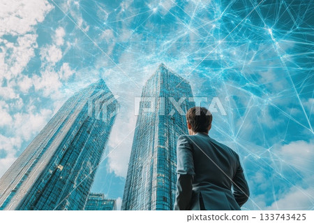 Businessman Gazing at Futuristic Cityscape with Digital Network Overlay 133743425