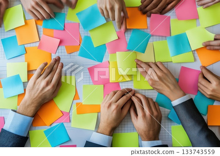 Creative Collaboration with Colorful Sticky Notes and Hands in Focus Creative Collaboration with Colorful Sticky Notes and Hands in Focus 133743559