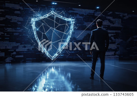 Businessman Examining Digital Shield Concept for Cybersecurity Protection Businessman Examining Digital Shield Concept for Cybersecurity Protection 133743605