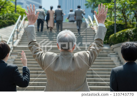 A man in a suit is waving his hands in the air A man in a suit is waving his hands in the air 133743770