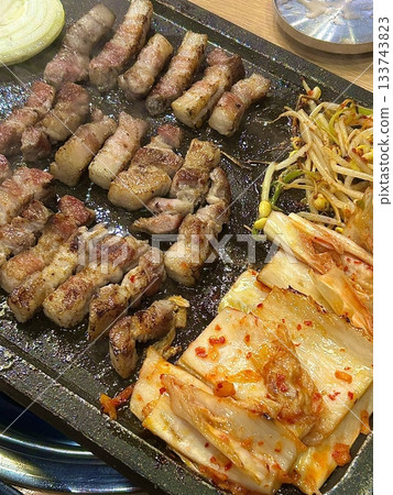 Juicy grilled samgyeopsal paired with savory mushrooms and tangy, sizzling kimchi, creating a perfect balance of rich, earthy, and spicy flavors in every delicious, mouthwatering bite. Juicy grilled samgyeopsal paired with savory mushrooms and tangy, sizzling kimchi, creating a perfect balance of rich, earthy, and spicy flavors in every delicious, mouthwatering bite. 133743823