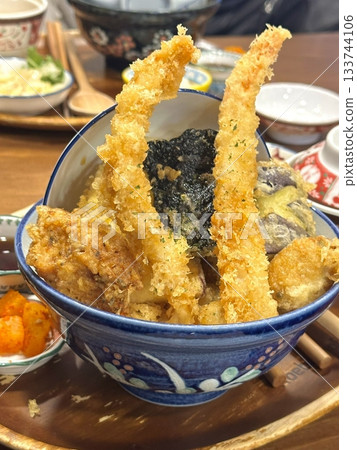 Ebi furai, crispy Japanese deep-fried shrimp, coated in golden panko breadcrumbs. A delicious and crunchy seafood dish, often paired with tartar sauce or served alongside fresh salad. Ebi furai, crispy Japanese deep-fried shrimp, coated in golden panko breadcrumbs. A delicious and crunchy seafood dish, often paired with tartar sauce or served alongside fresh salad. 133744106