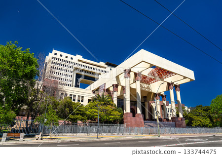 View of the National Congress of Chile building in Valparaiso. The massive modern government structure features large columns and a wide entrance under a deep blue sky 133744475