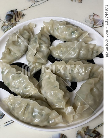 Korean dumplings filled with a mix of savory ingredients like ground meat, tofu, and vegetables. Mandu can be steamed, boiled, or pan-fried, making it a versatile and delicious snack or meal. Korean dumplings filled with a mix of savory ingredients like ground meat, tofu, and vegetables. Mandu can be steamed, boiled, or pan-fried, making it a versatile and delicious snack or meal. 133744973