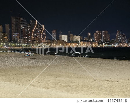 city evening ambiance, sunset cityscape with calming shores, urban twilight with serene ocean 133745248