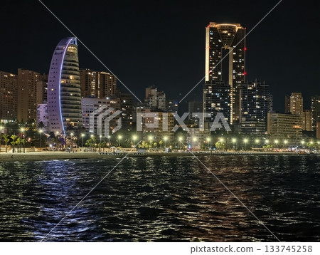 waterline view with shimmering reflections, gentle ripples and illuminated towers create atmosphere waterline view with shimmering reflections, gentle ripples and illuminated towers create atmosphere 133745258