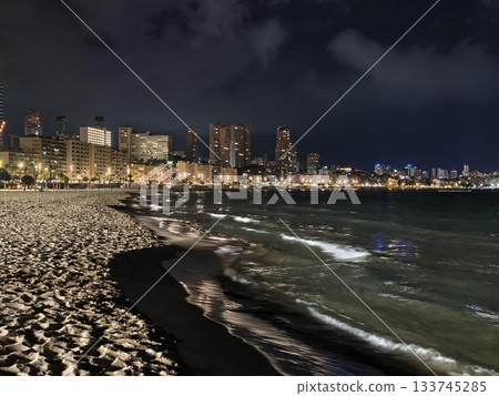 city waves glow, vibrant urban energy blends seamlessly with rhythmic motions of nighttime ocean city waves glow, vibrant urban energy blends seamlessly with rhythmic motions of nighttime ocean 133745285