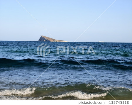 calm coastal island vista, tranquil seaside landscape featuring sandy beach and rocky outcrop calm coastal island vista, tranquil seaside landscape featuring sandy beach and rocky outcrop 133745318