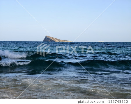 contemplative maritime landscape scene, distant rocky island with textured waves and blue hues contemplative maritime landscape scene, distant rocky island with textured waves and blue hues 133745320
