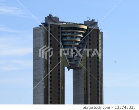 photographer captures minimalist highrise with geometric symmetry and distant airplane on horizon photographer captures minimalist highrise with geometric symmetry and distant airplane on horizon 133745323