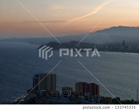 serene twilight over coastal towers, ethereal twilight casting soft haze over misty seafront 133745335