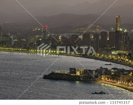 serene harbor with boats and lights, nighttime harbor scene with boats and glowing beacons 133745357
