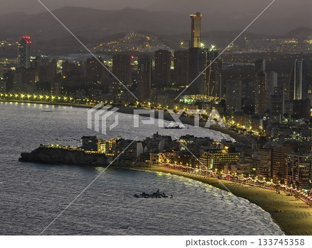 churning waves and dark clouds at dusk, stormy evening over coast with turbulent sea and ominous 133745358
