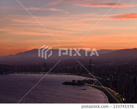 orange pink horizon lights, dramatic sunset with colorful streaks over water and mountains orange pink horizon lights, dramatic sunset with colorful streaks over water and mountains 133745376