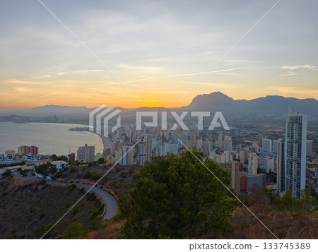 serene sunset scene, peaceful sunset illuminating cityscape with solitary shrub and distant serene sunset scene, peaceful sunset illuminating cityscape with solitary shrub and distant 133745389