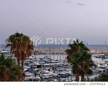 gentle marina under pastel sky, serene waterfront scene featuring calm waters and pastelhued sky 133745412