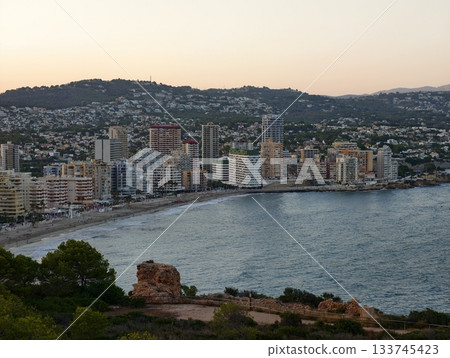 colorful waterfront with sunset hues, sunlit crescent bay features vibrant buildings and rocky colorful waterfront with sunset hues, sunlit crescent bay features vibrant buildings and rocky 133745423