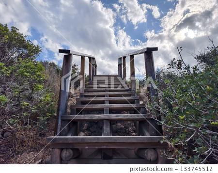 old wooden stairs stretch upward toward sky, rustic wooden stairs reach up high into clear sky above old wooden stairs stretch upward toward sky, rustic wooden stairs reach up high into clear sky above 133745512