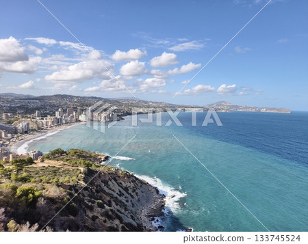 colorful seaside landscape description, scenic turquoise coast with layered beaches and city 133745524