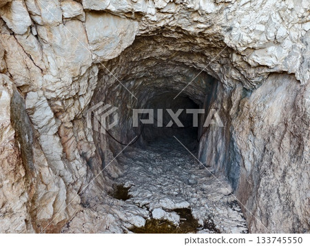 cave reflection highlight, rocky cave interior featuring water reflection and dramatic lighting 133745550