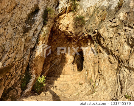 cave stairs explore, sunlit rocky stairway within cave, worn steps in coastal cave evoke history cave stairs explore, sunlit rocky stairway within cave, worn steps in coastal cave evoke history 133745579