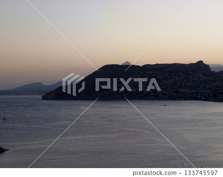 calm evening landscape, serene sunset over quiet bay, peaceful headland scene with pastel sky calm evening landscape, serene sunset over quiet bay, peaceful headland scene with pastel sky 133745597