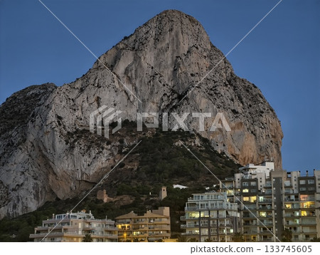 evening city contrast, dusk illuminates cityscape contrasting with mountain silhouette and night sky evening city contrast, dusk illuminates cityscape contrasting with mountain silhouette and night sky 133745605