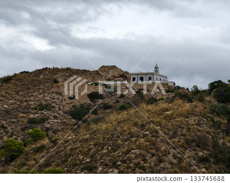 hilltop chapel silhouette, remote chapel above arid slopes, whitewashed chapel atop dry hillside hilltop chapel silhouette, remote chapel above arid slopes, whitewashed chapel atop dry hillside 133745688