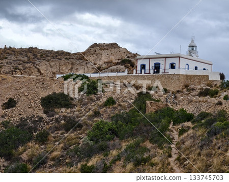 rugged coastal sanctuary with bell tower, serene seaside chapel featuring arched facade and bell rugged coastal sanctuary with bell tower, serene seaside chapel featuring arched facade and bell 133745703