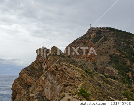 rocky promontory facing stormy sea raw cliffs rising against turbulent sky 133745708