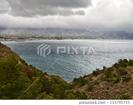 wild stormy coast, powerful scene of stormy weather featuring windswept trees and blurred city wild stormy coast, powerful scene of stormy weather featuring windswept trees and blurred city 133745735