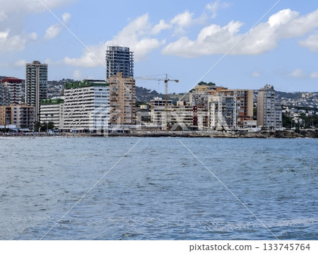 sunny harbor with buildings and boats, bright seaside skyline featuring modern apartments and harbor sunny harbor with buildings and boats, bright seaside skyline featuring modern apartments and harbor 133745764