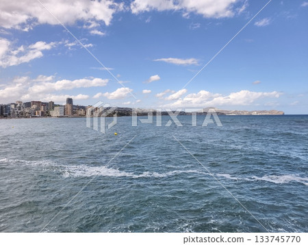 expansive ocean view under sunny sky, peaceful water body featuring distant land and gentle ripples expansive ocean view under sunny sky, peaceful water body featuring distant land and gentle ripples 133745770