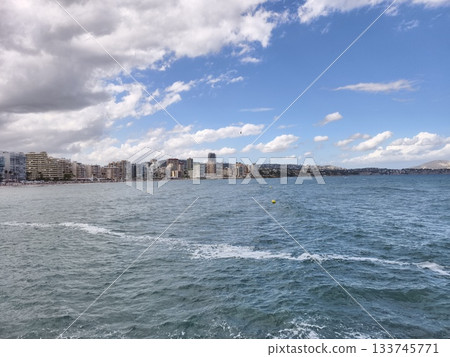 bustling seaside with scenic skyline, lively waterfront featuring sparkling ocean views and urban 133745771