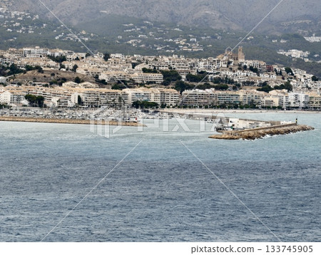 calm seaside view, calm seaside scene showcasing marina with boats and beautiful mountain scenery 133745905