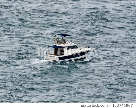 swift yacht produces foamy wake, speedy yacht moving swiftly creates foamy wake extending behind it 133745907