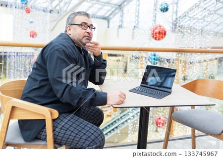 Businessman in suit and sunglasses working on laptop in modern office. High quality photo Businessman in suit and sunglasses working on laptop in modern office. High quality photo 133745967