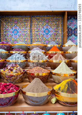 Traditional spices market. Pots and wooden tubs stand in row with colorful tea, spices, fruits, roots, flowers. Street bazaar. Dubai, UAE. Vertical photo Traditional spices market. Pots and wooden tubs stand in row with colorful tea, spices, fruits, roots, flowers. Street bazaar. Dubai, UAE. Vertical photo 133746093