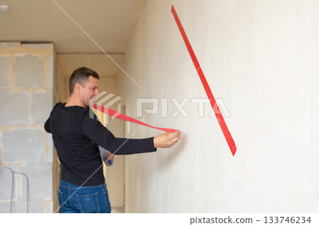 Man hugging his wife. Young couple moving in new apartmen. View from side. Concept new homes, new beginning. High quality photo 133746234