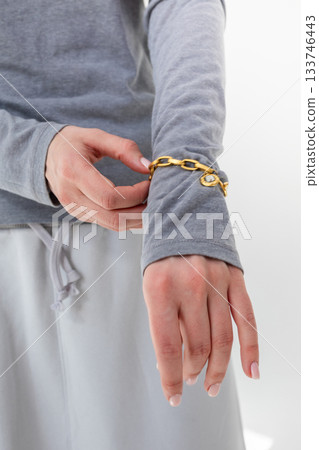 Woman fastening bracelet on hand close-up. Vertical photo. High quality photo Woman fastening bracelet on hand close-up. Vertical photo. High quality photo 133746443